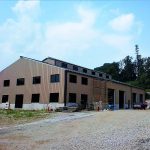 A building that is being built in the dirt.