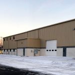 A large warehouse with lots of windows and doors.